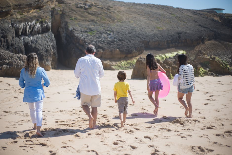Family walking together on a sunny Portuguese beach. Perfect for vacations.