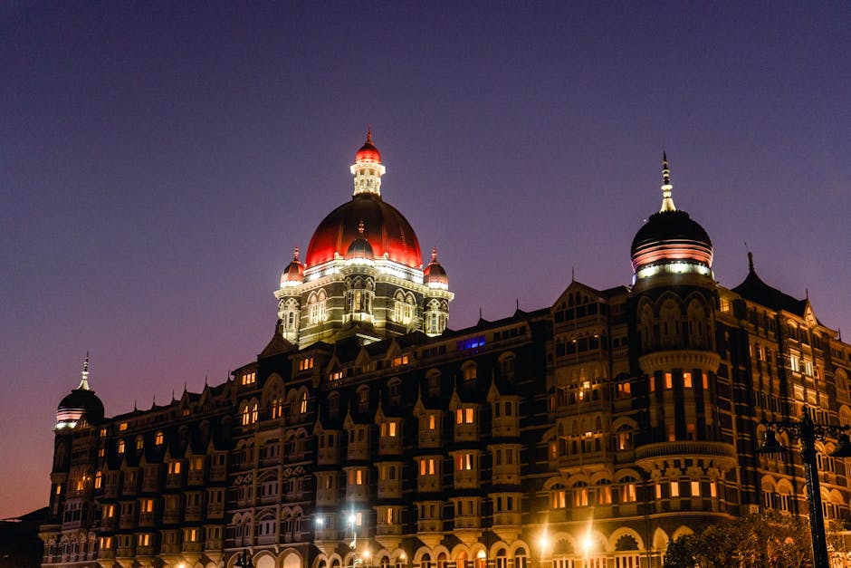 The iconic Taj Mahal Palace in Mumbai illuminated by twilight, showcasing its grand architecture.