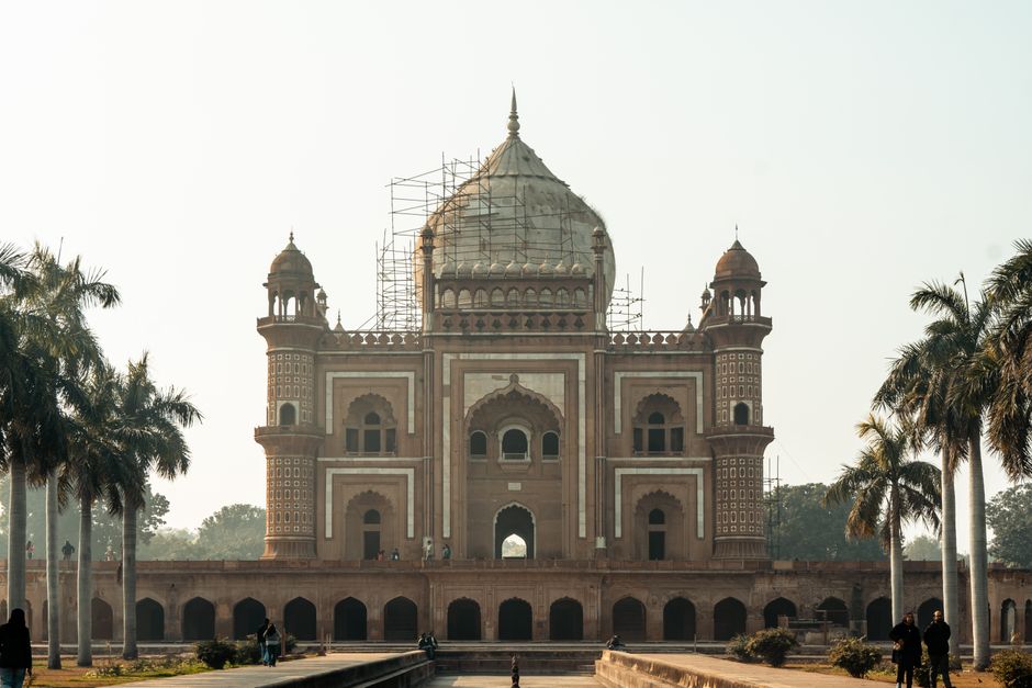 Front view of the iconic Safdarjung Tomb in New Delhi, surrounded by palm trees.